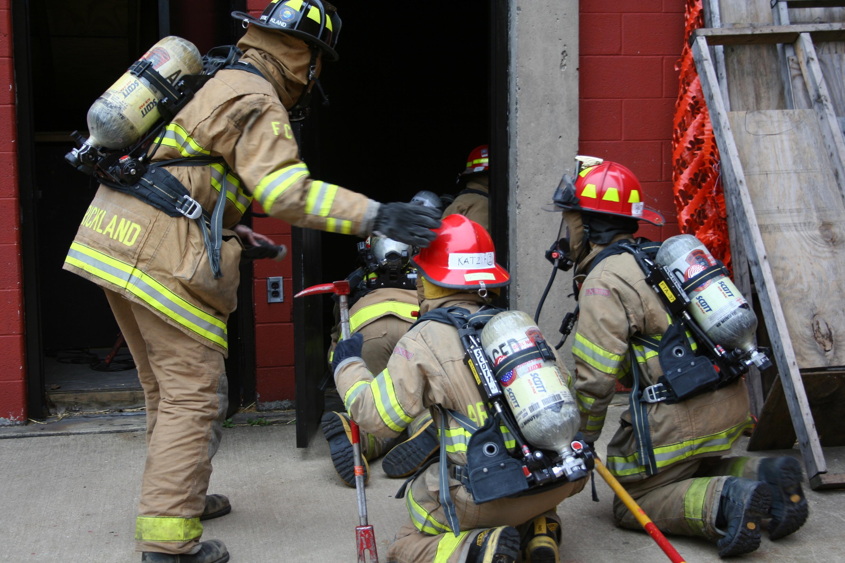 firefighters entering a building