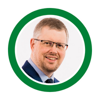 Stephen Forshaw, a white man, goatee, brown hair, glasses and suit with tie